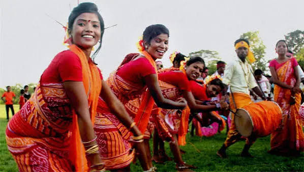 Women in traditional dress performing a group dance during a Nuakhai celebration